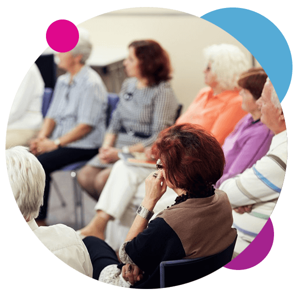 group of seniors listening to volunteer speaker